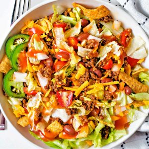 catalina taco salad in a bowl with a fork on a table.