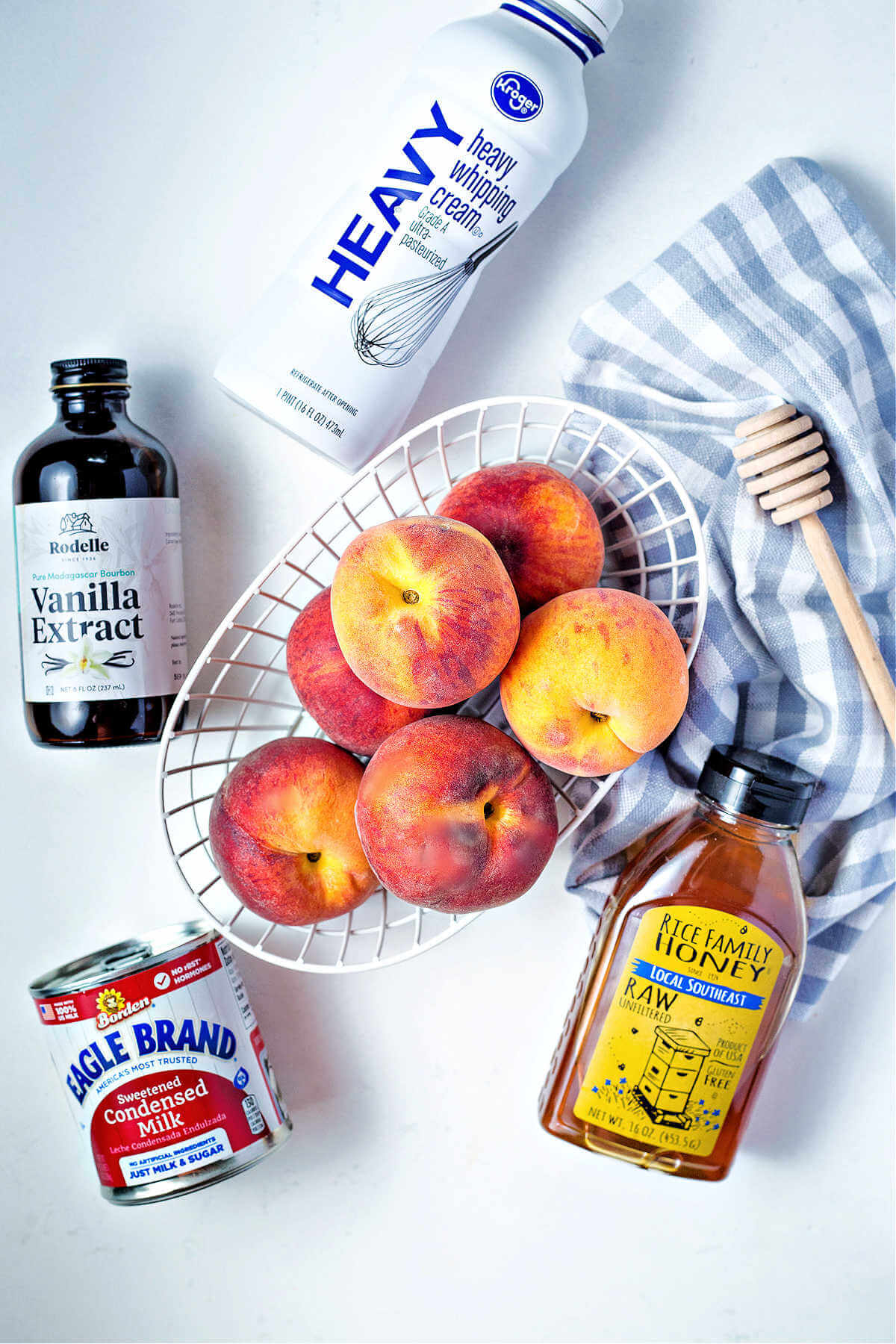 ingredients for homemade peach ice cream on a table.