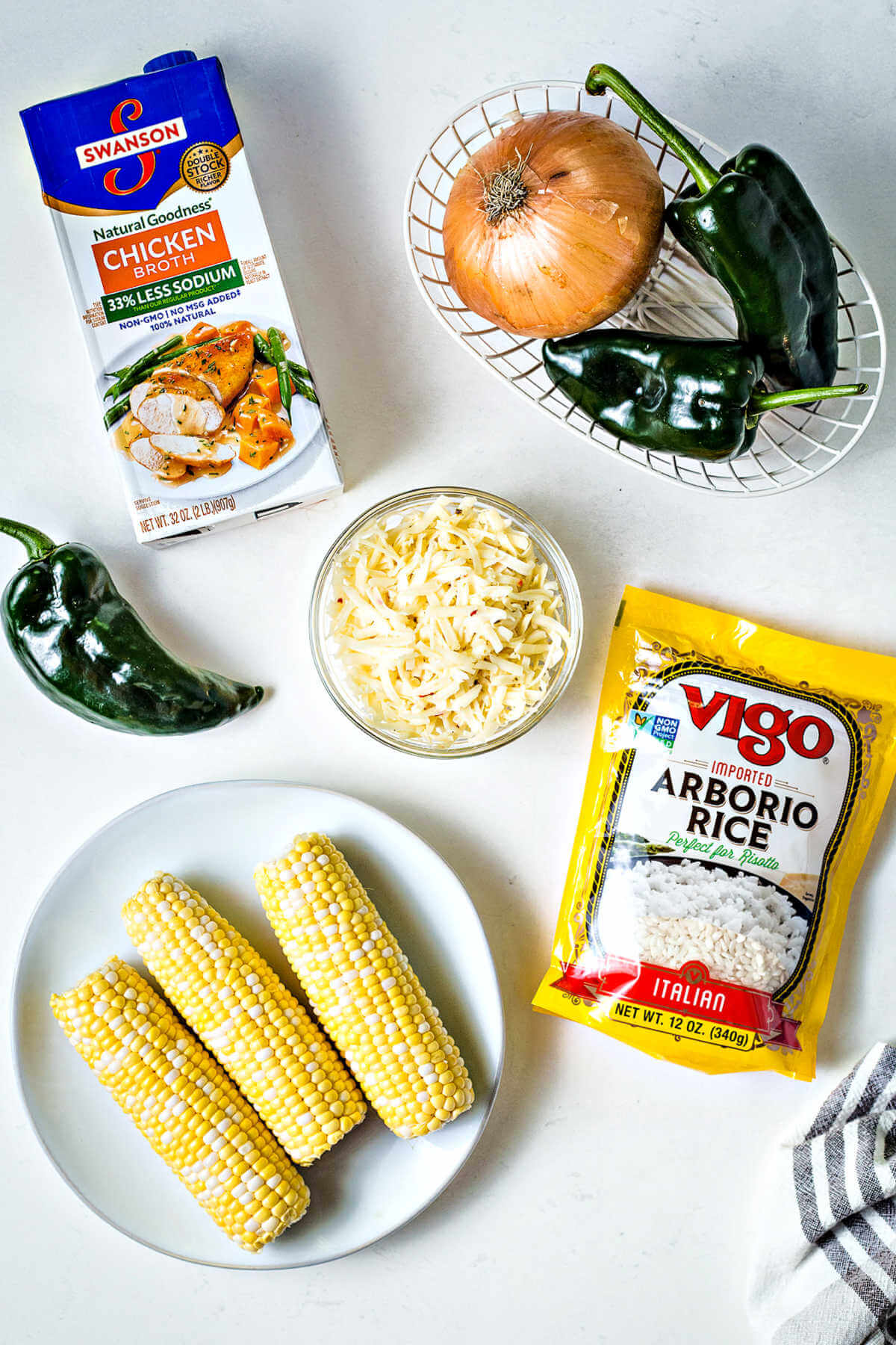 ingredients for arroz poblano (corn and poblano rice) on a table.