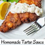 fried catfish on a plate with tartar sauce drizzled on top.