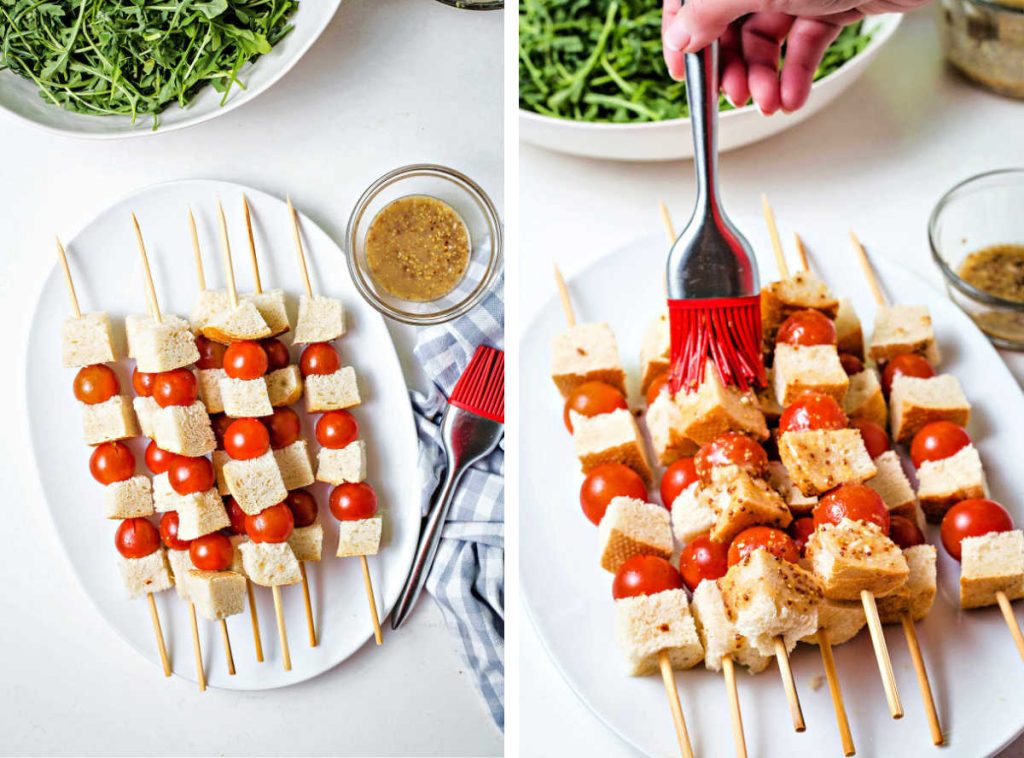 a platter of skewers with bread cubes and cherry tomatoes; basting vinaigrette on skewers for grilled panzanella salad.
