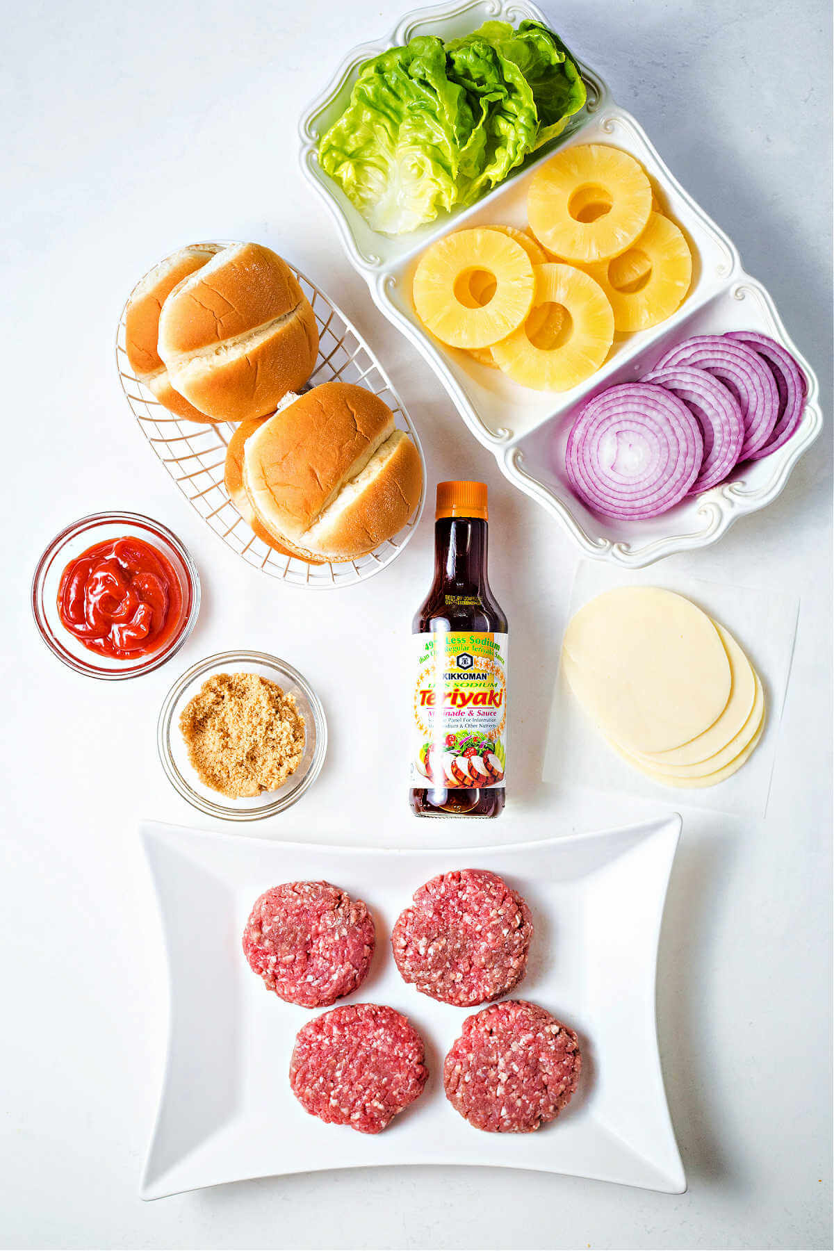ingredients for making hawaiian burger on a table.