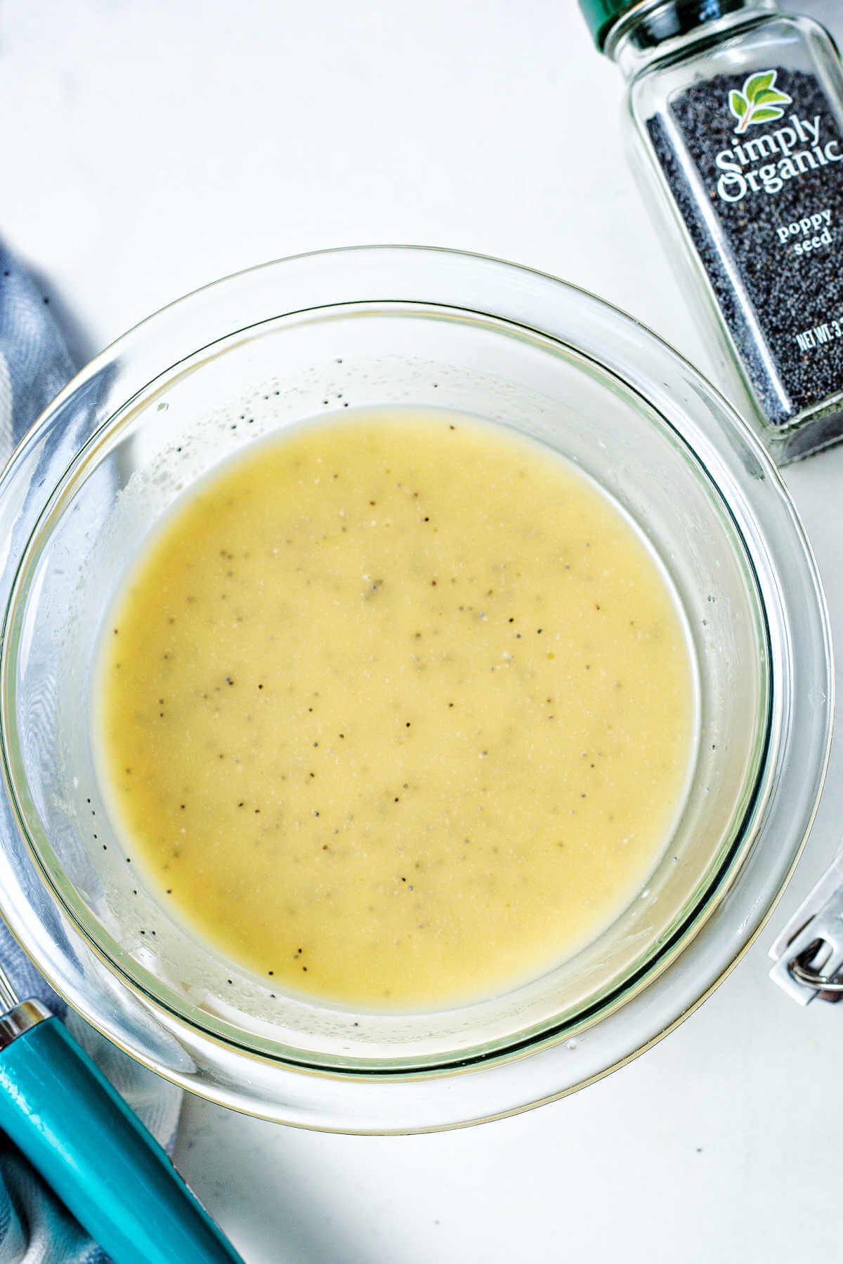 poppy seed dressing in a bowl after being whisked together.