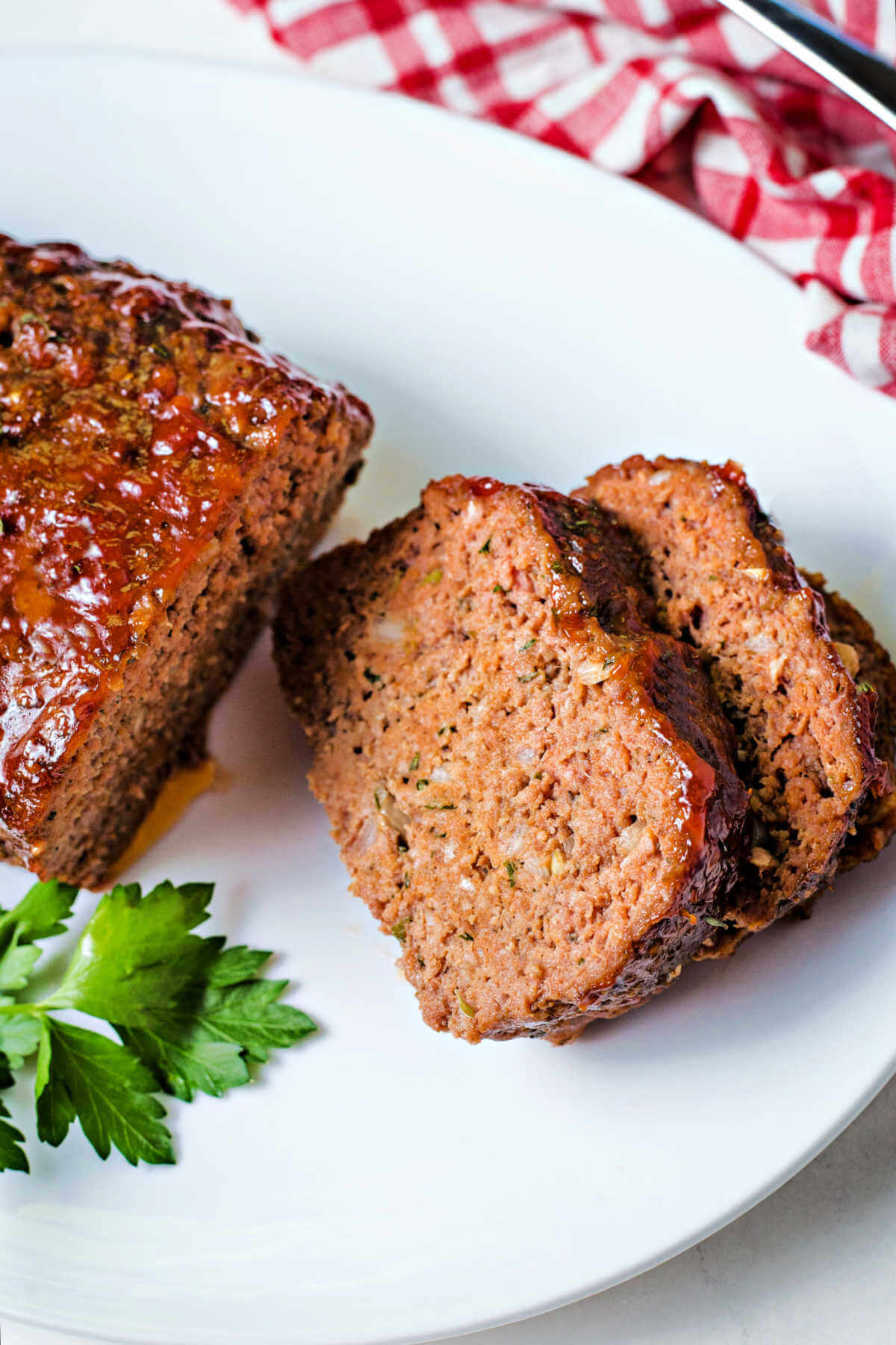 two slices of smoked meatloaf on a plate.