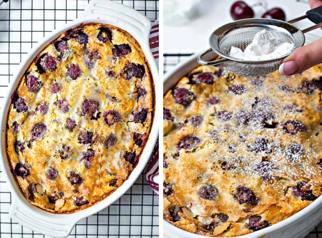 cherry clafoutis cooling on a wire rack; dusting powdered sugar through a fine mesh strainer..