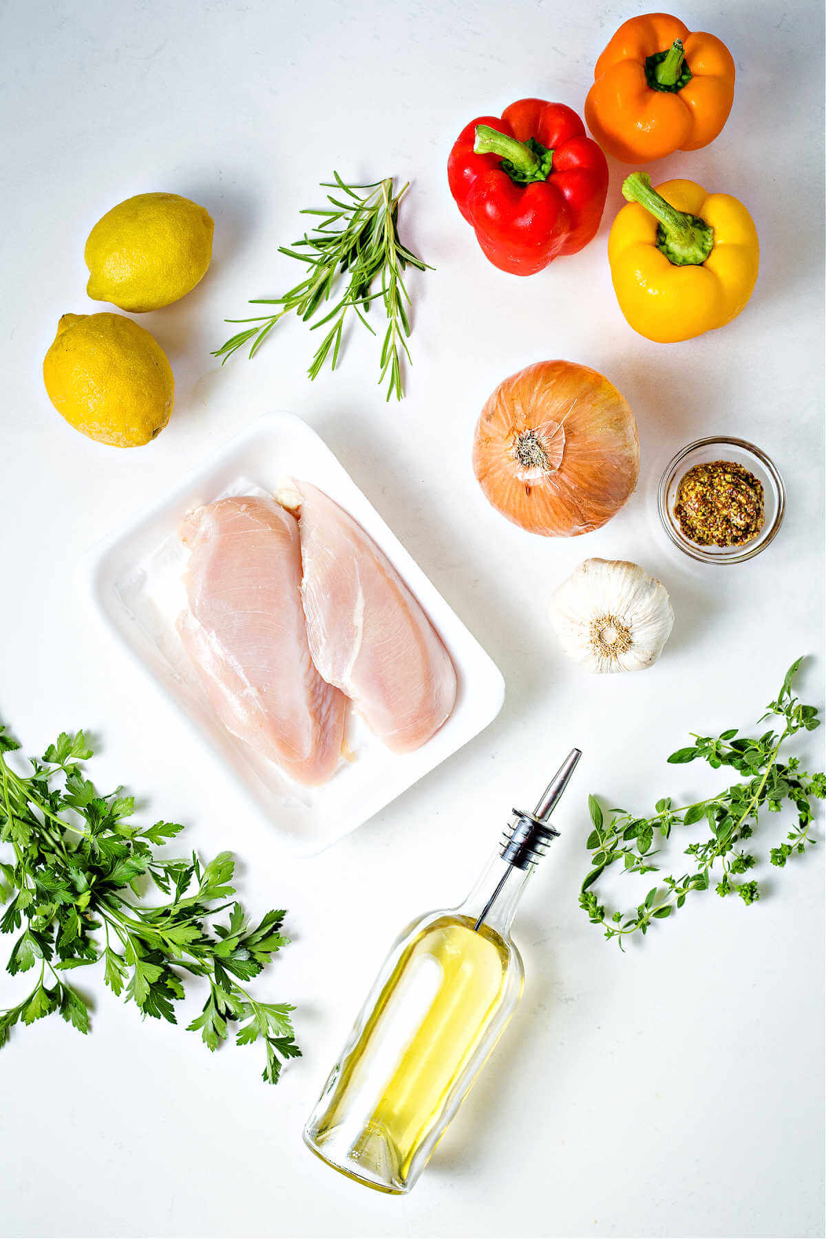 ingredients for greek chicken kabobs on a table.