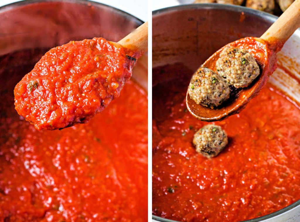 a wooden spoon in a simmering pot of marinara with meatballs.