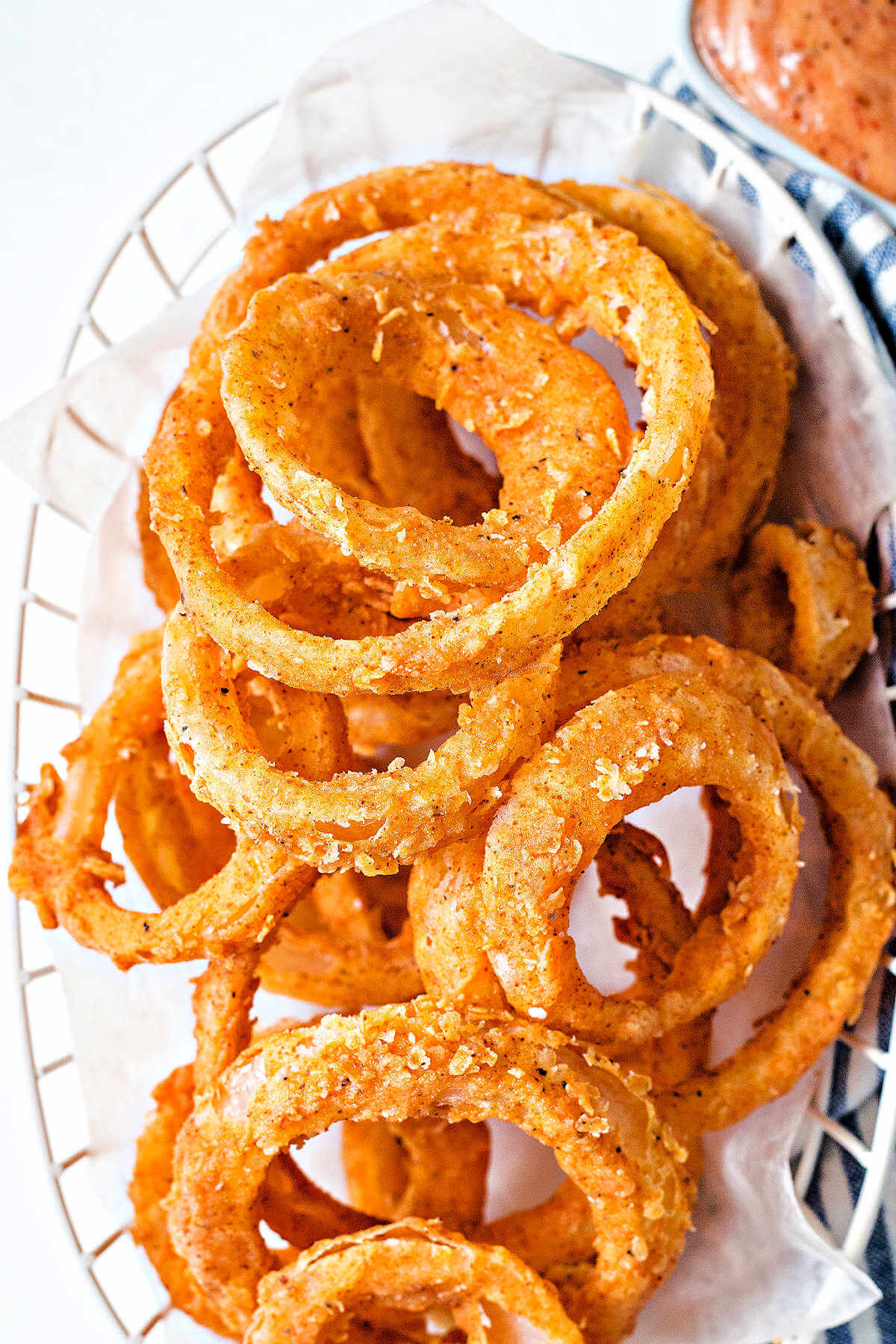 a basket of fried onion rings on a table.
