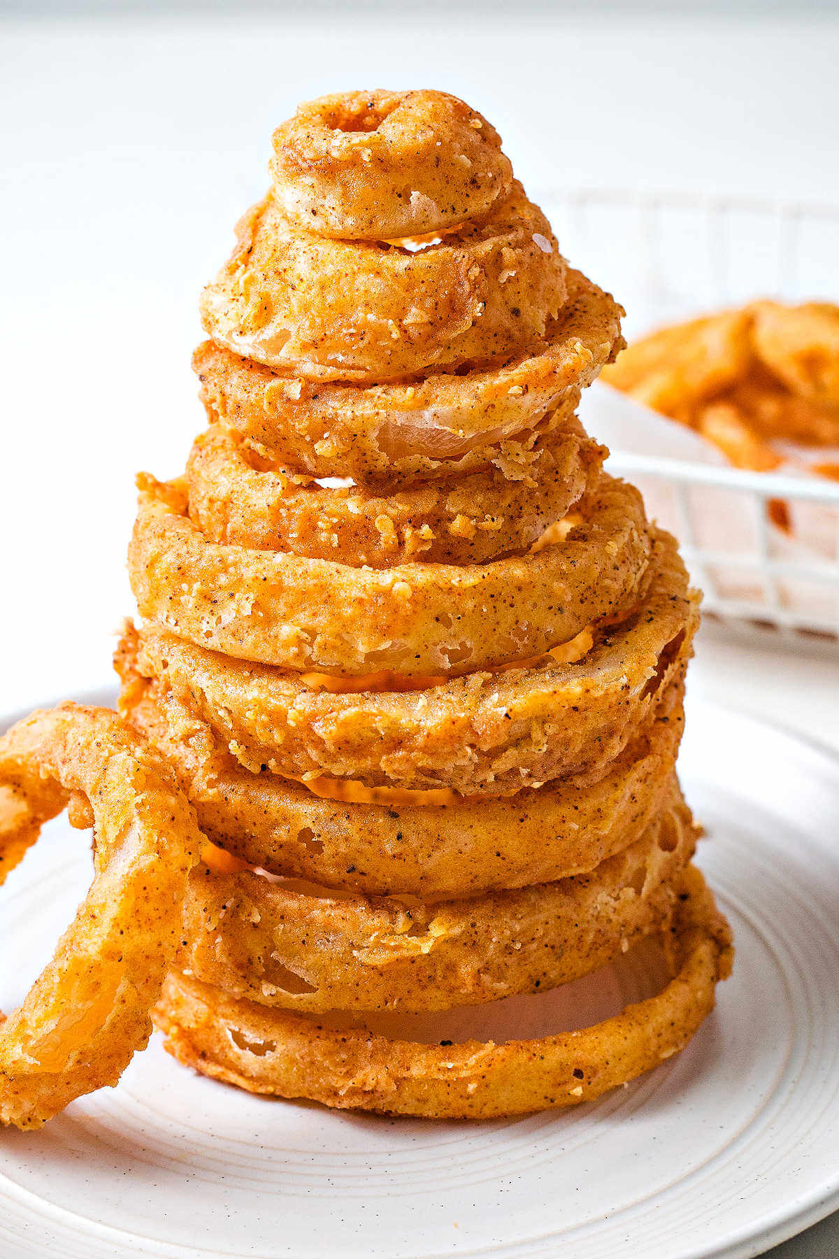 onion rings stacked into a tower on a plate.