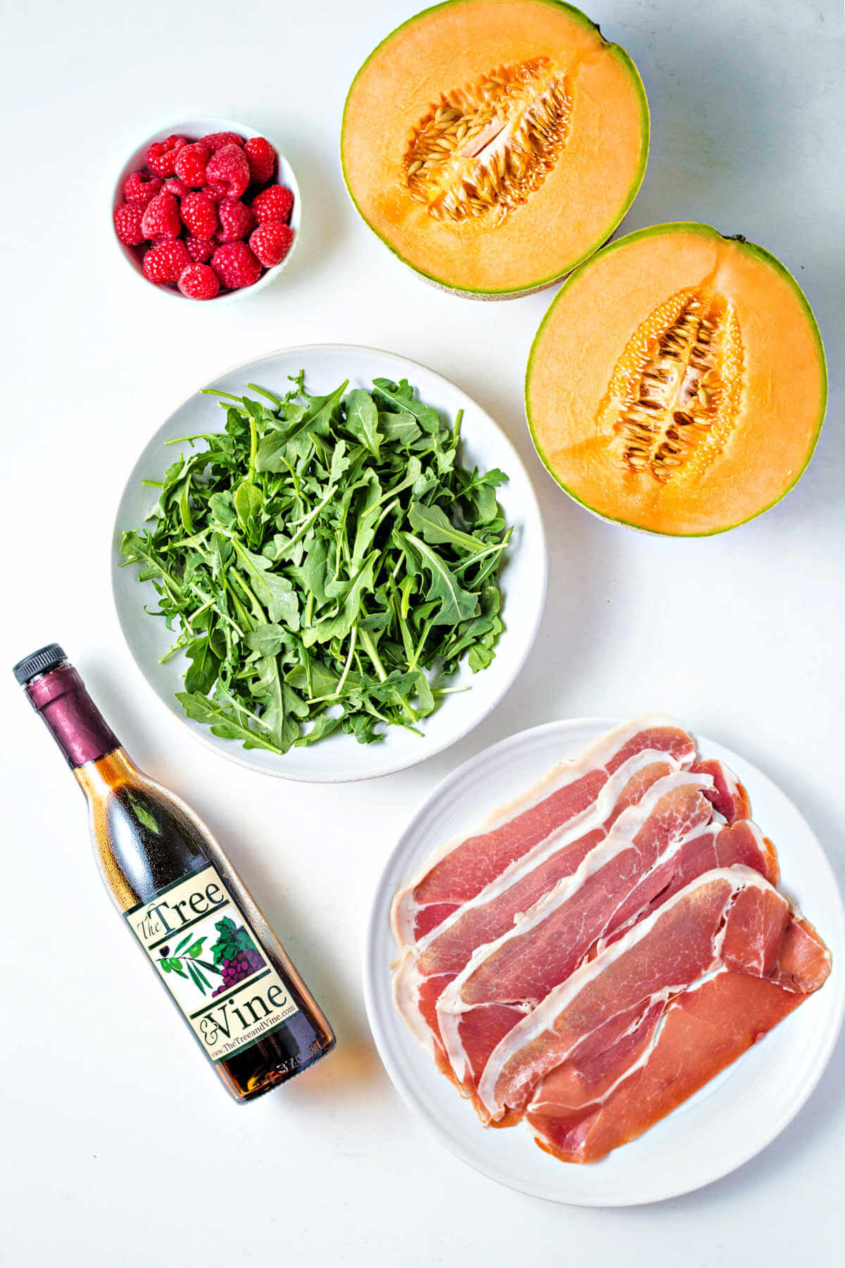 ingredients for Prosciutto and Melon on a table.