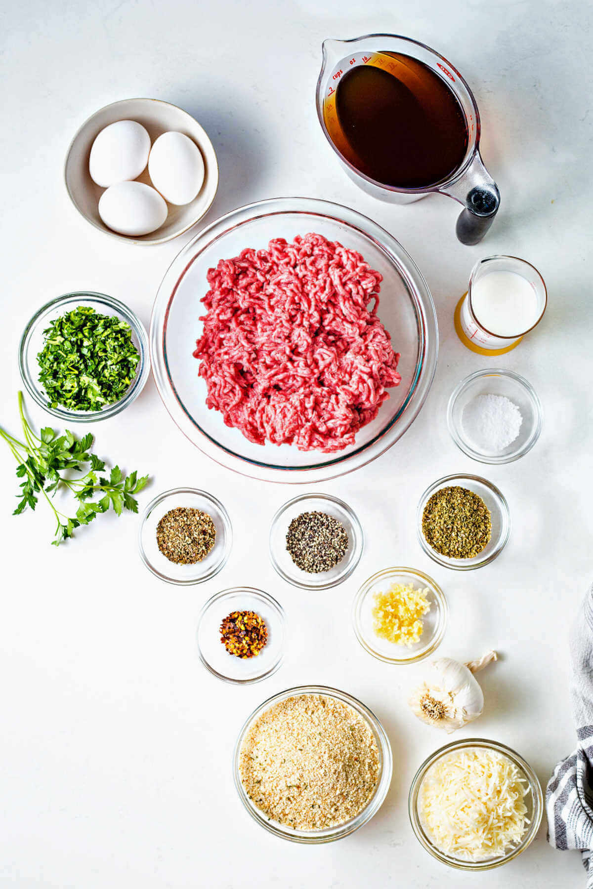 ingredients for making meatballs on a table.
