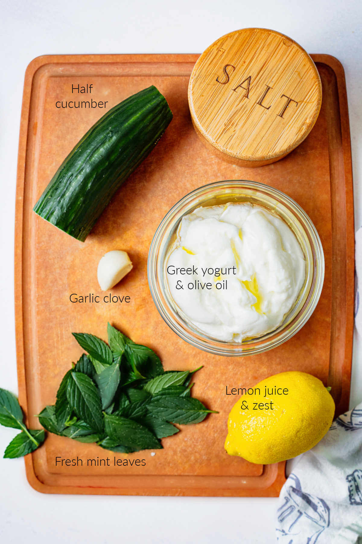 ingredients for Tzatziki Sauce on a cuttiing board.