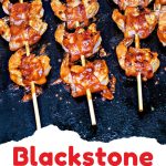 Bacon Wrapped Shrimp on skewers on a blackstone griddle.