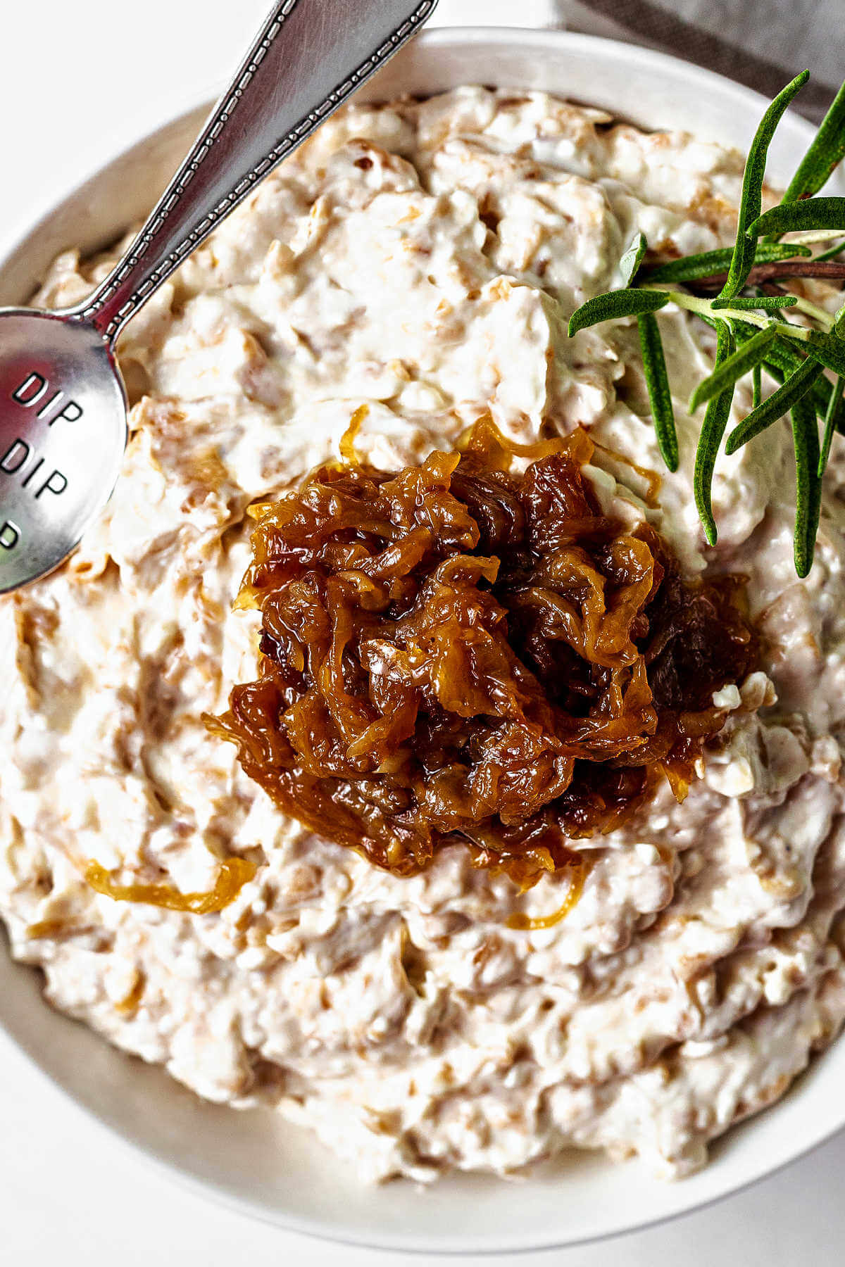 caramelized onion dip in a bowl with a spoon.