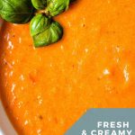 Creamy Tomato Soup garnished with fresh basil in a bowl.