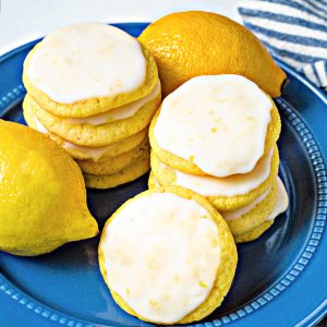 two slacks of lemon cake mix cookies on a blue plate with lemons.