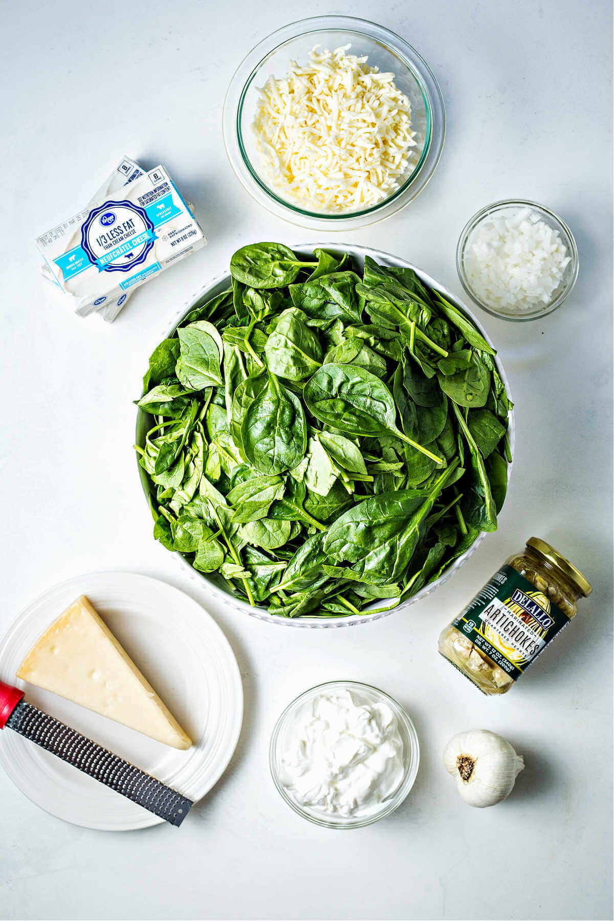 ingredients for slow cooker spinach artichoke dip on a table.