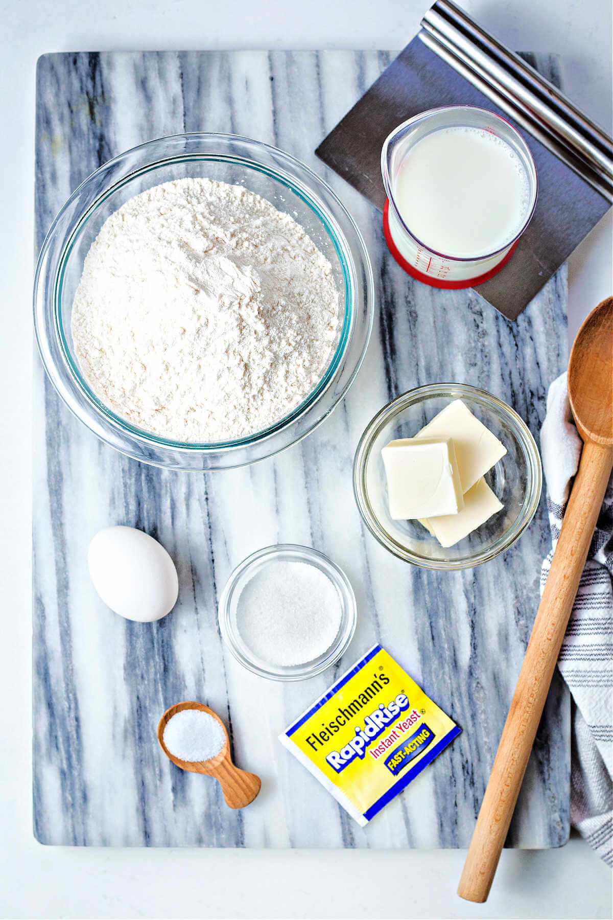 ingredients for homemade yeast dinner rolls on a table.