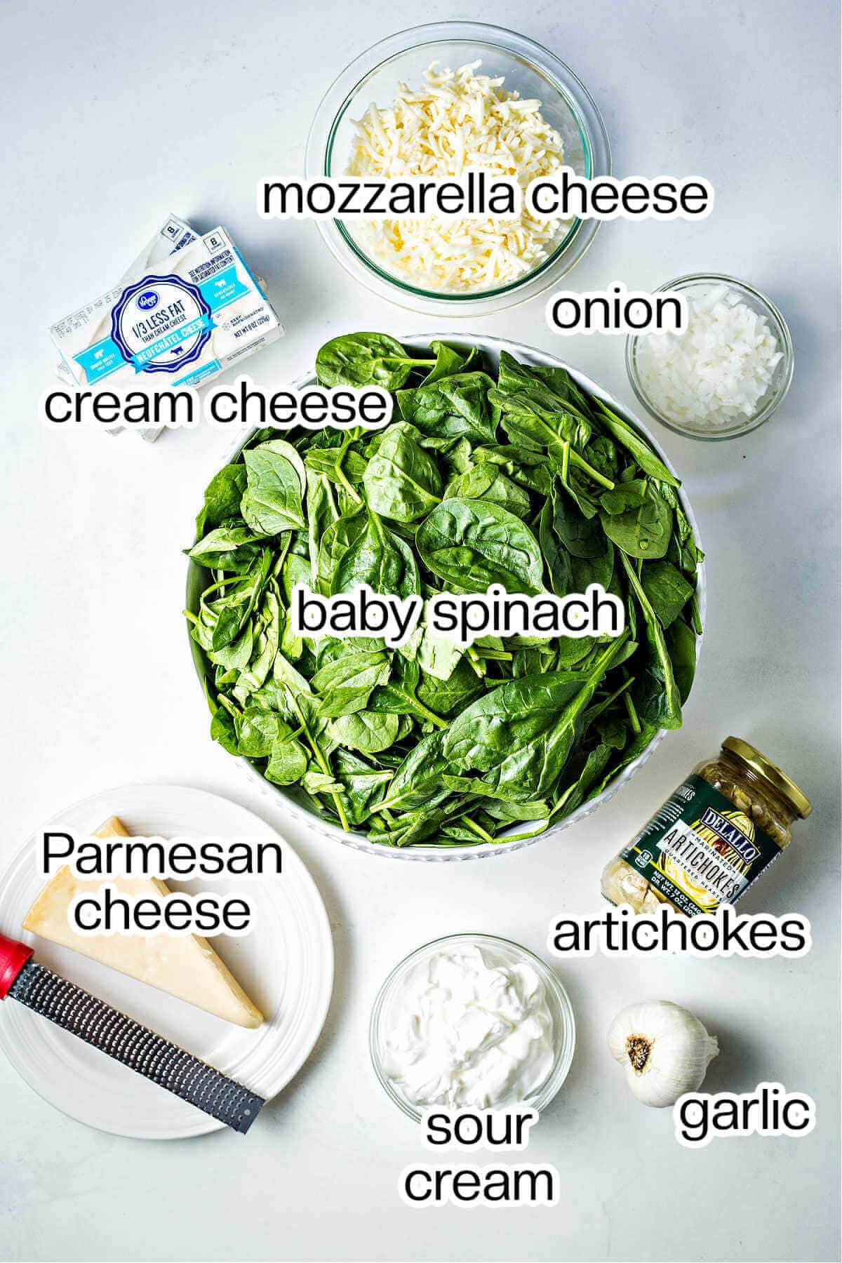 ingredients for slow cooker spinach artichoke dip on a table.