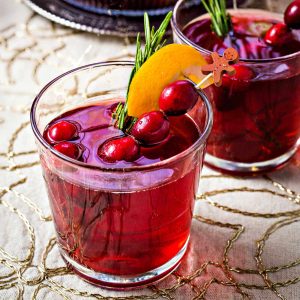 two glasses of cranberry white grape punch on a table.