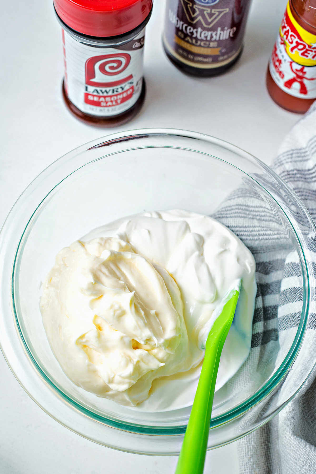 mayonnaise and sour cream in a bowl with a spatula.