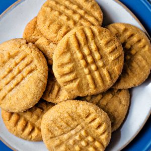soft peanut butter cookies piled on a plate.