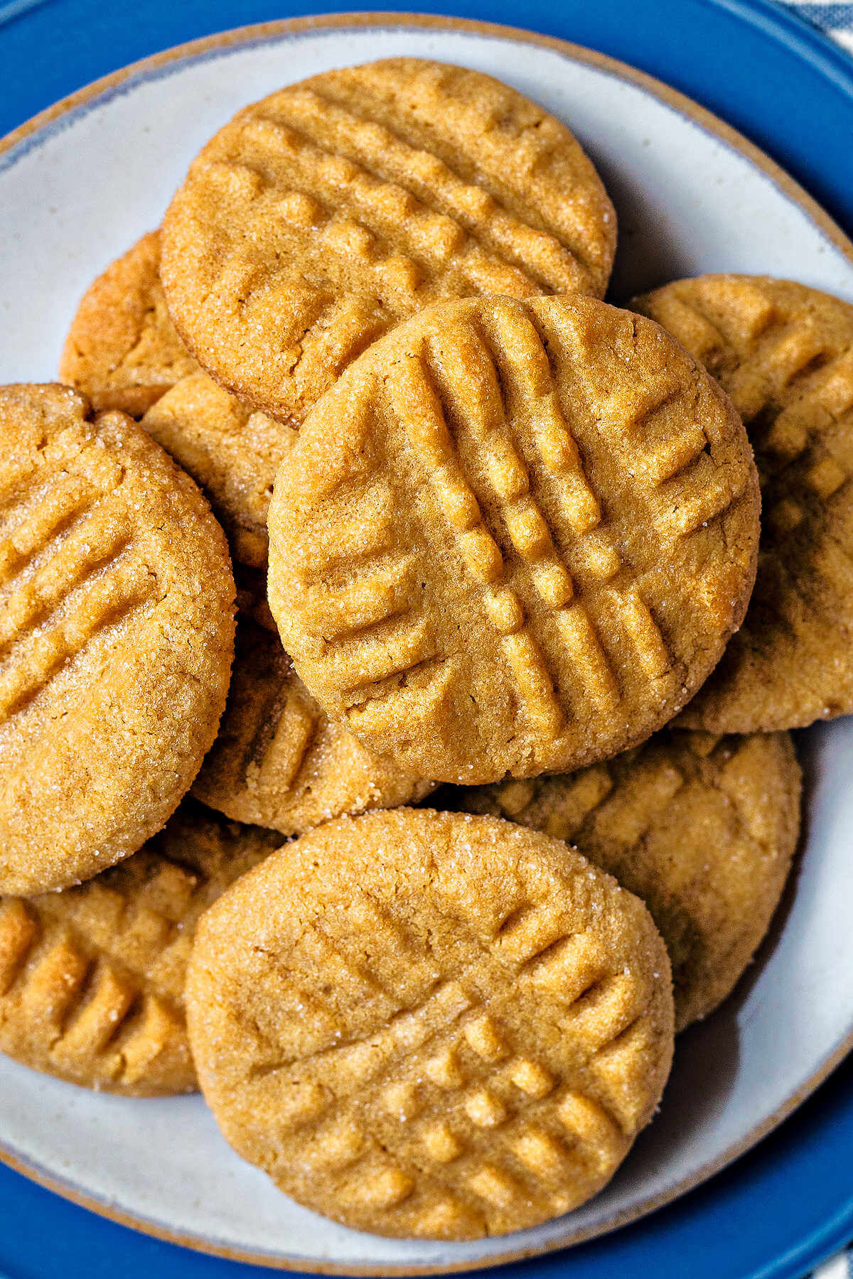 soft peanut butter cookies piled on a plate.