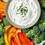 VEGETABLE DIP ON A PLATTER WITH RAW VEGETABLES.