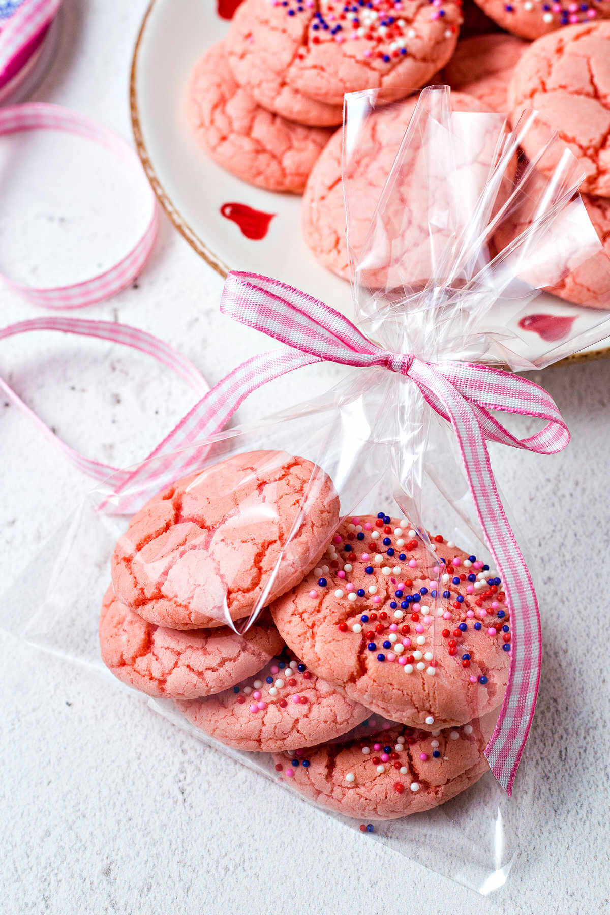 strawberry cake mix cookies wrapped in a goodie bag with a pink ribbon.