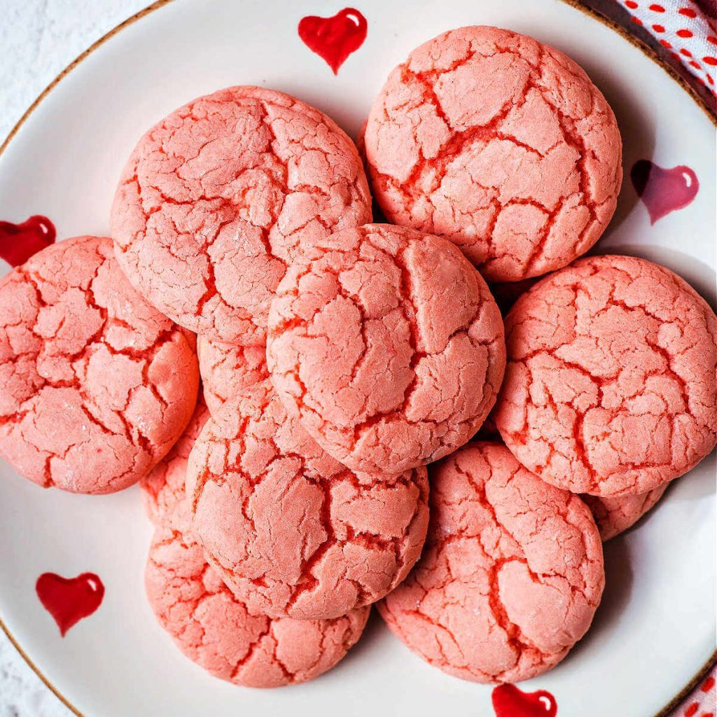 3-ingredient strawberry cake mix cookies on a valentine plate on a table.