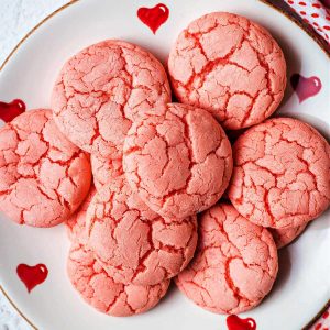 3-ingredient strawberry cake mix cookies on a valentine plate on a table.