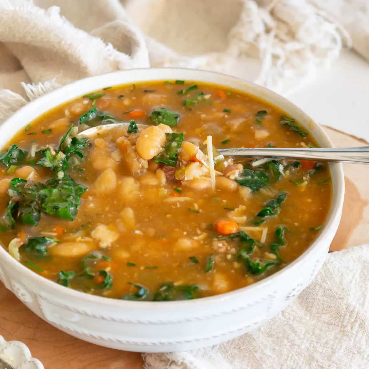 Tuscan bean soup in a white bowl.