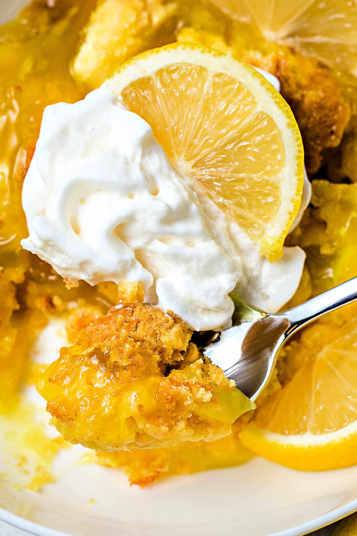 a spoon in a bowl of lemon dump cake.