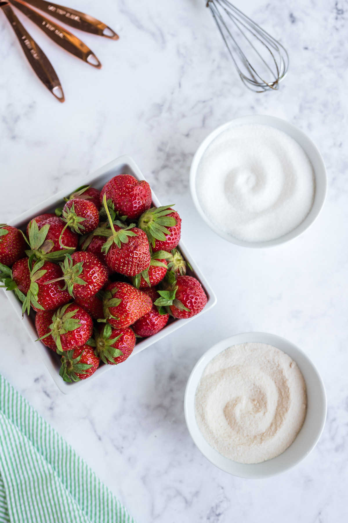 ingredients for strawberry jam on a table.