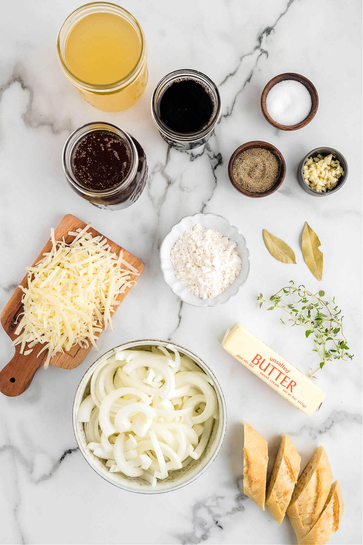 ingredients for French onion soup on a table.