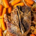 Slow Cooker Pork Roast on a platter with carrots and onions.