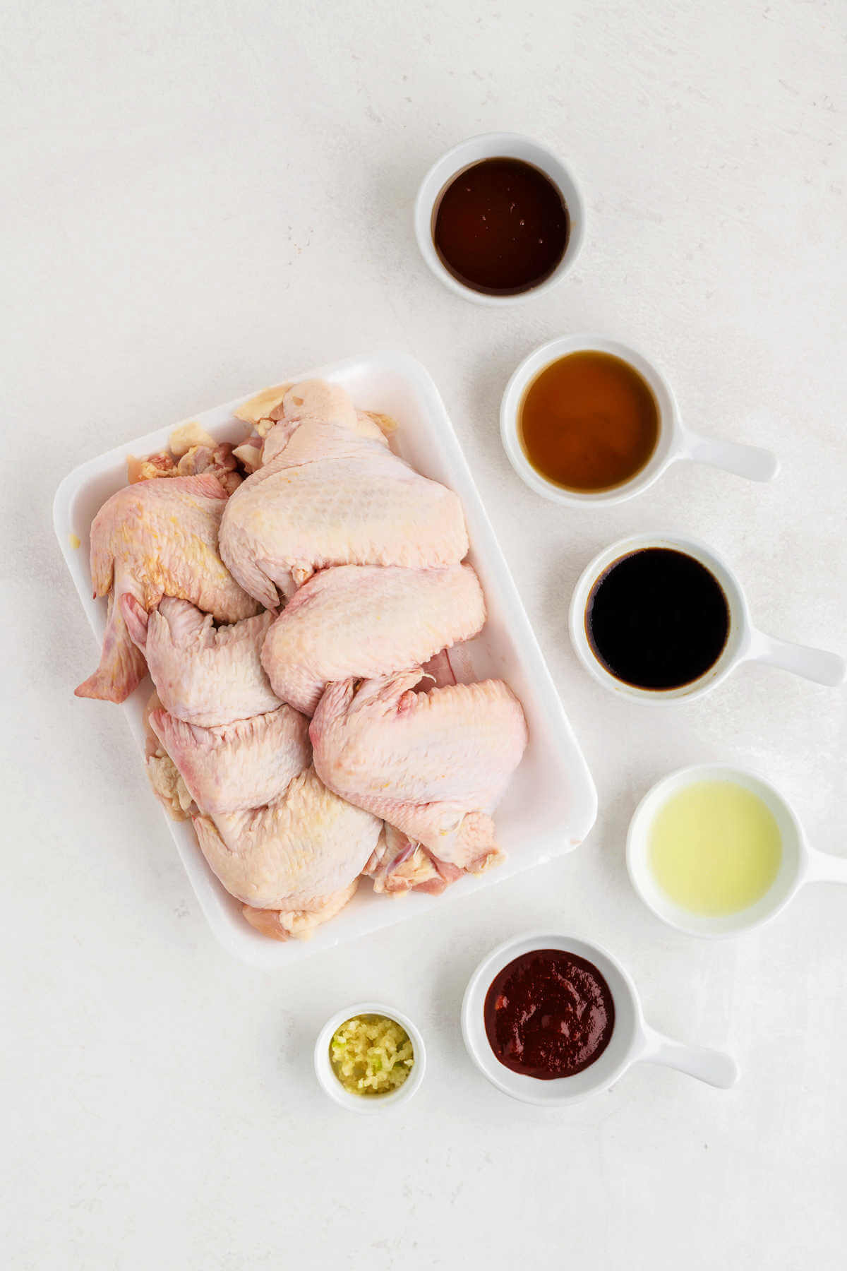 ingredients for sticky baked chicken wings on a table.