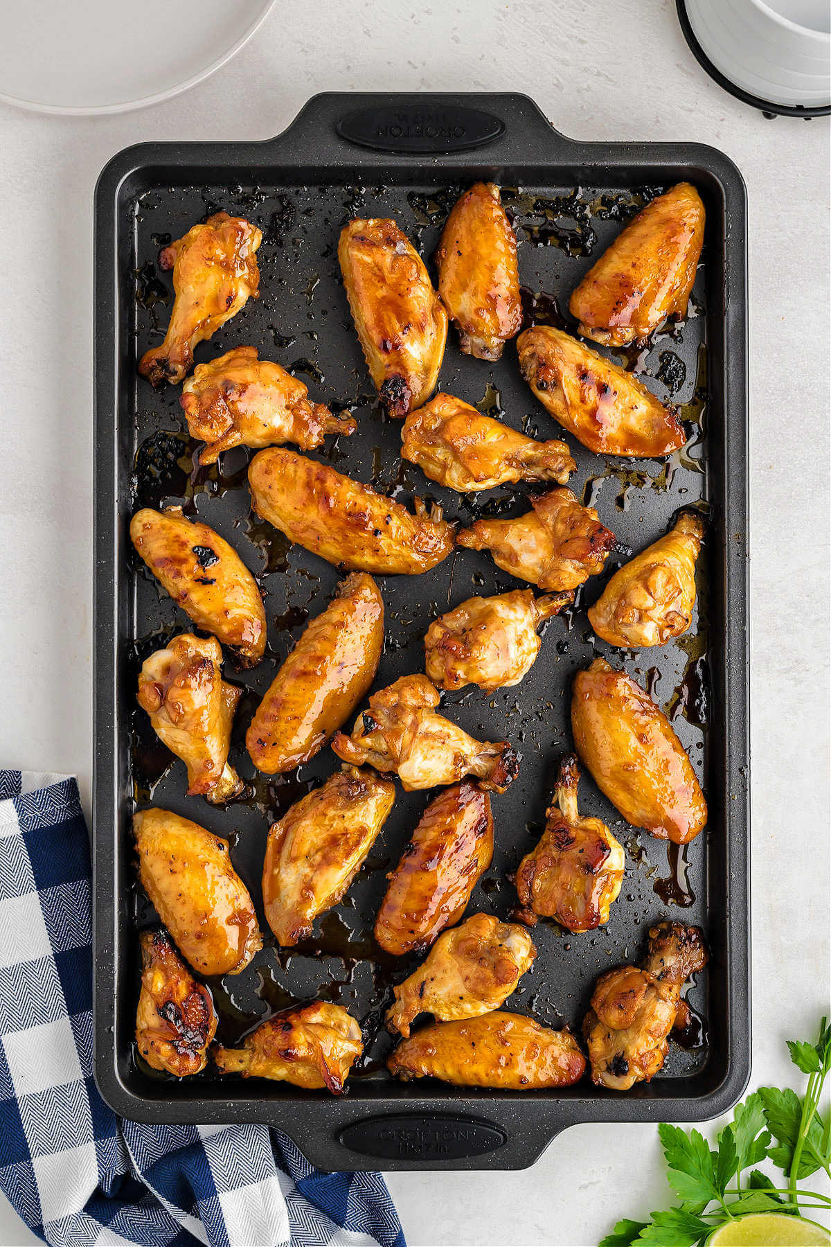 sticky baked chicken wings on a baking sheet.
