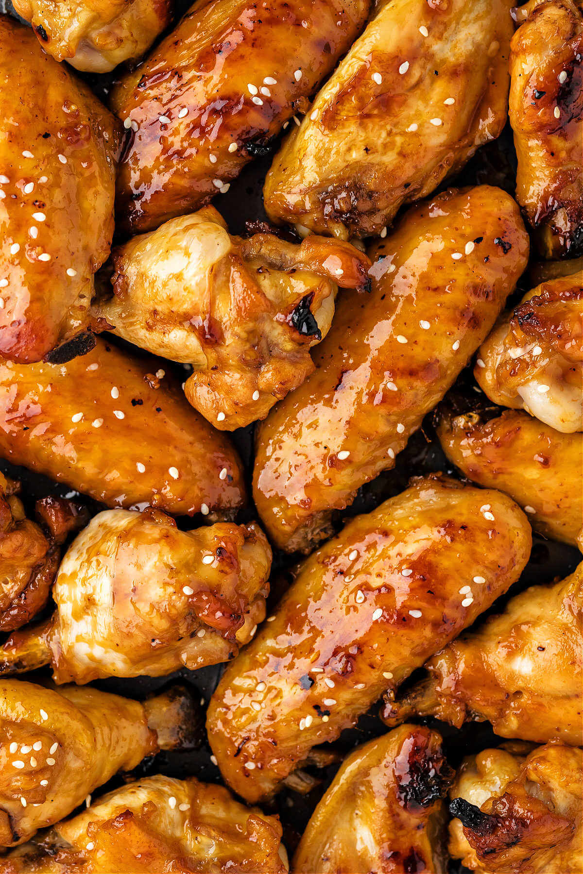 sticky baked chicken wings piled on top of each other.