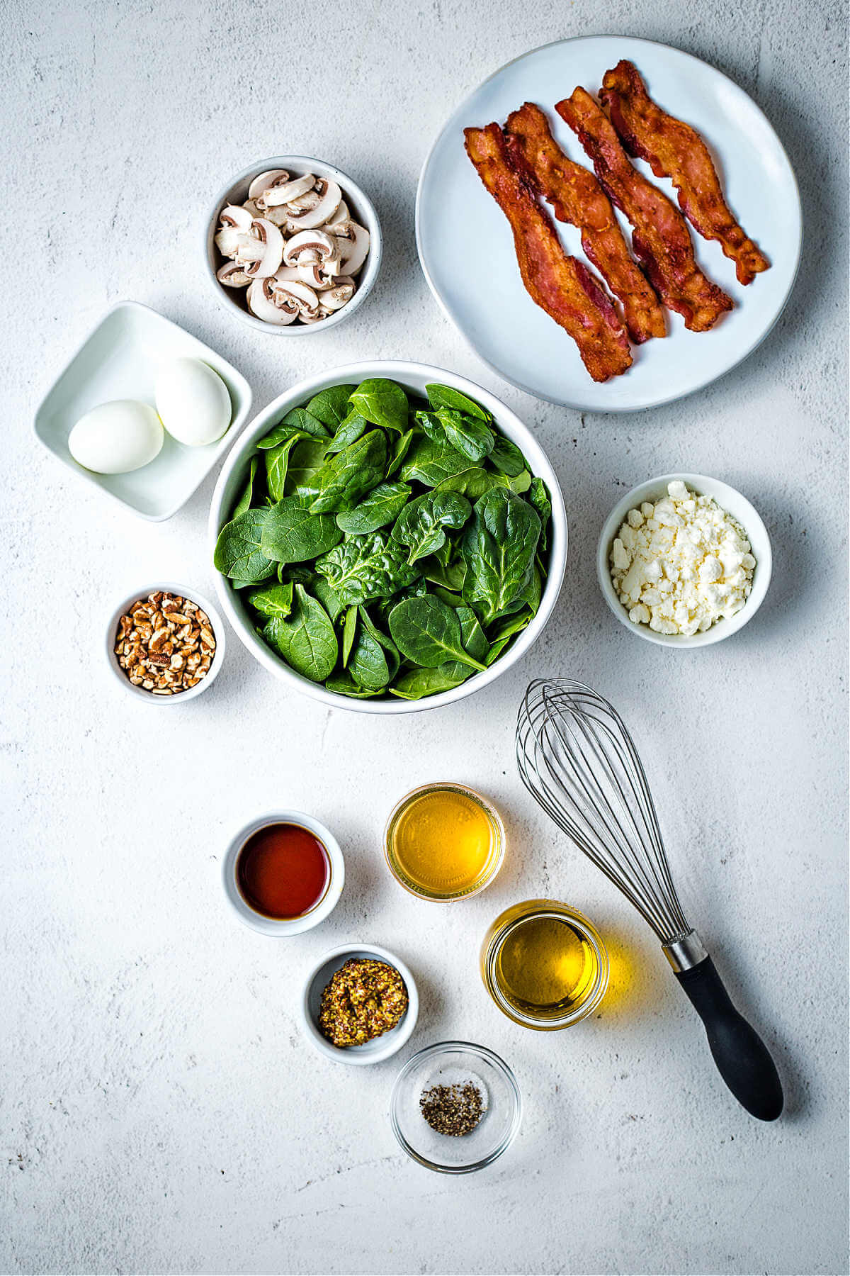 ingredients for spinach salad and dressing on a table.