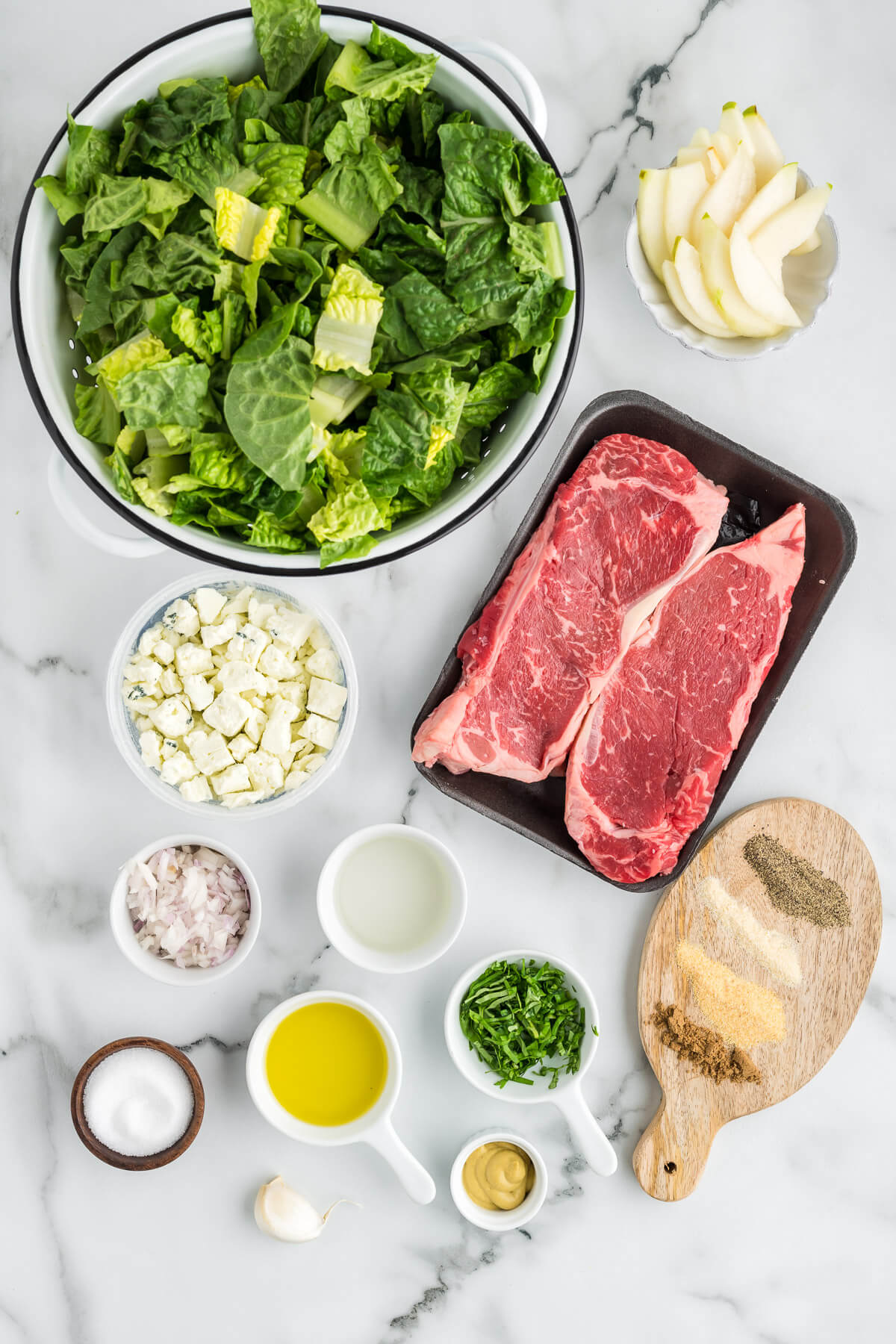 ingredients for grilled steak salad on a table.