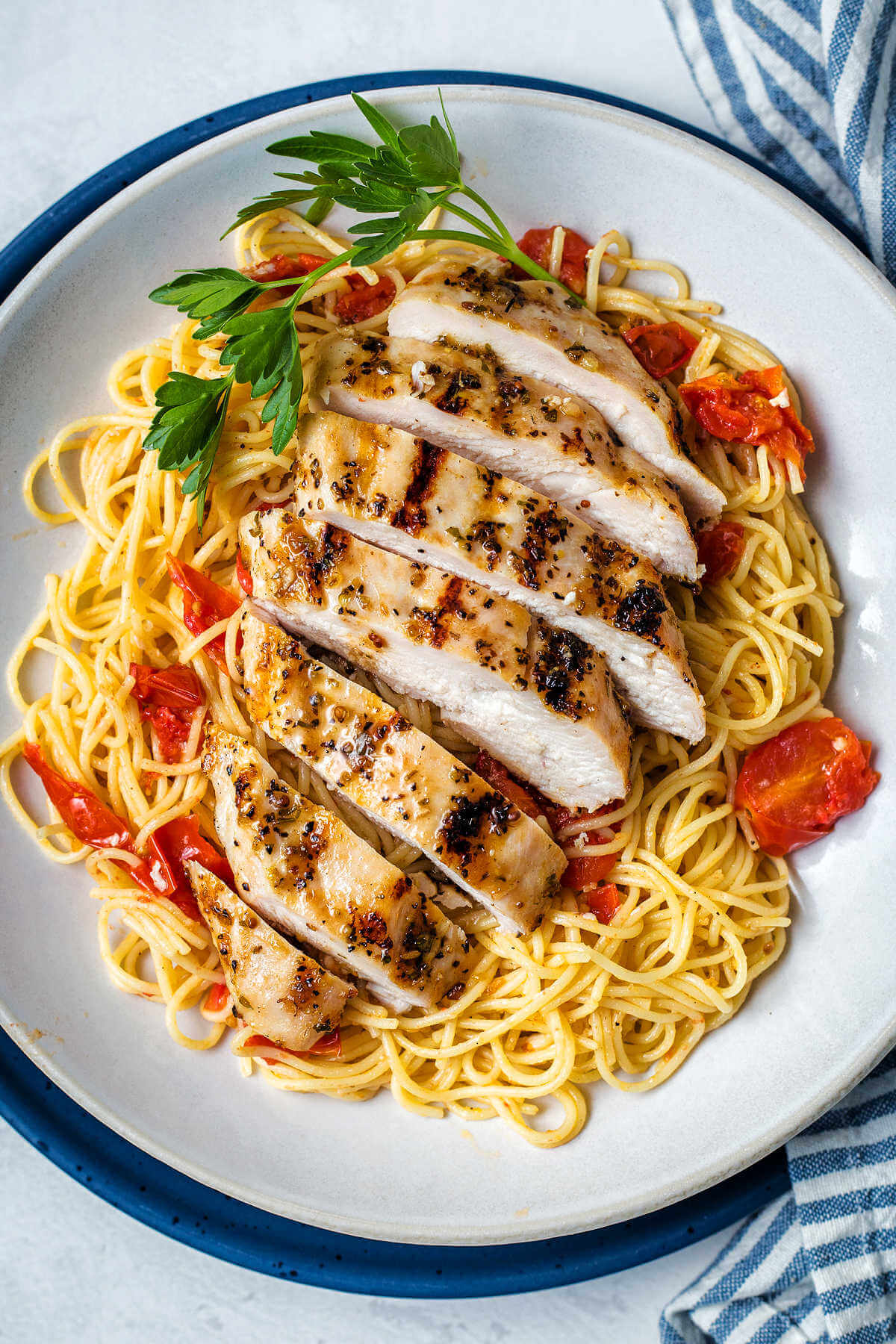 Italian grilled chicken sliced and served on a bed of pasta.