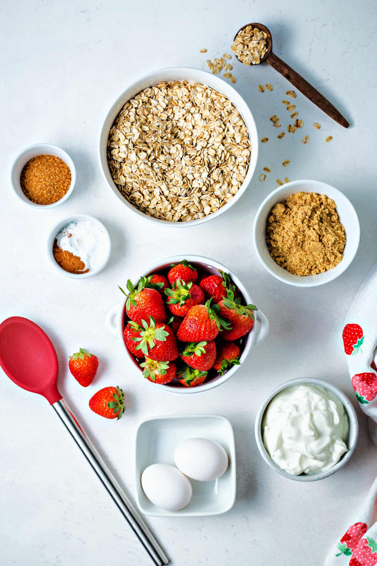 ingredients for strawberry oat muffins on a table.