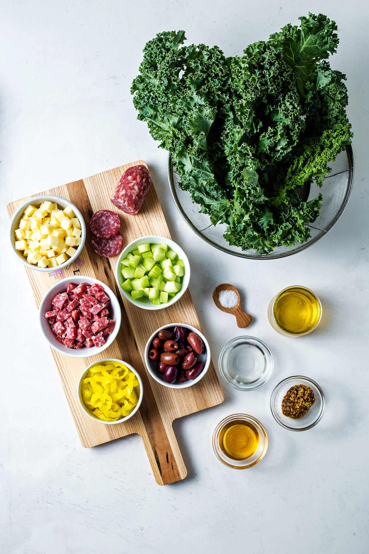 ingredients for chopped kale salad on a table.