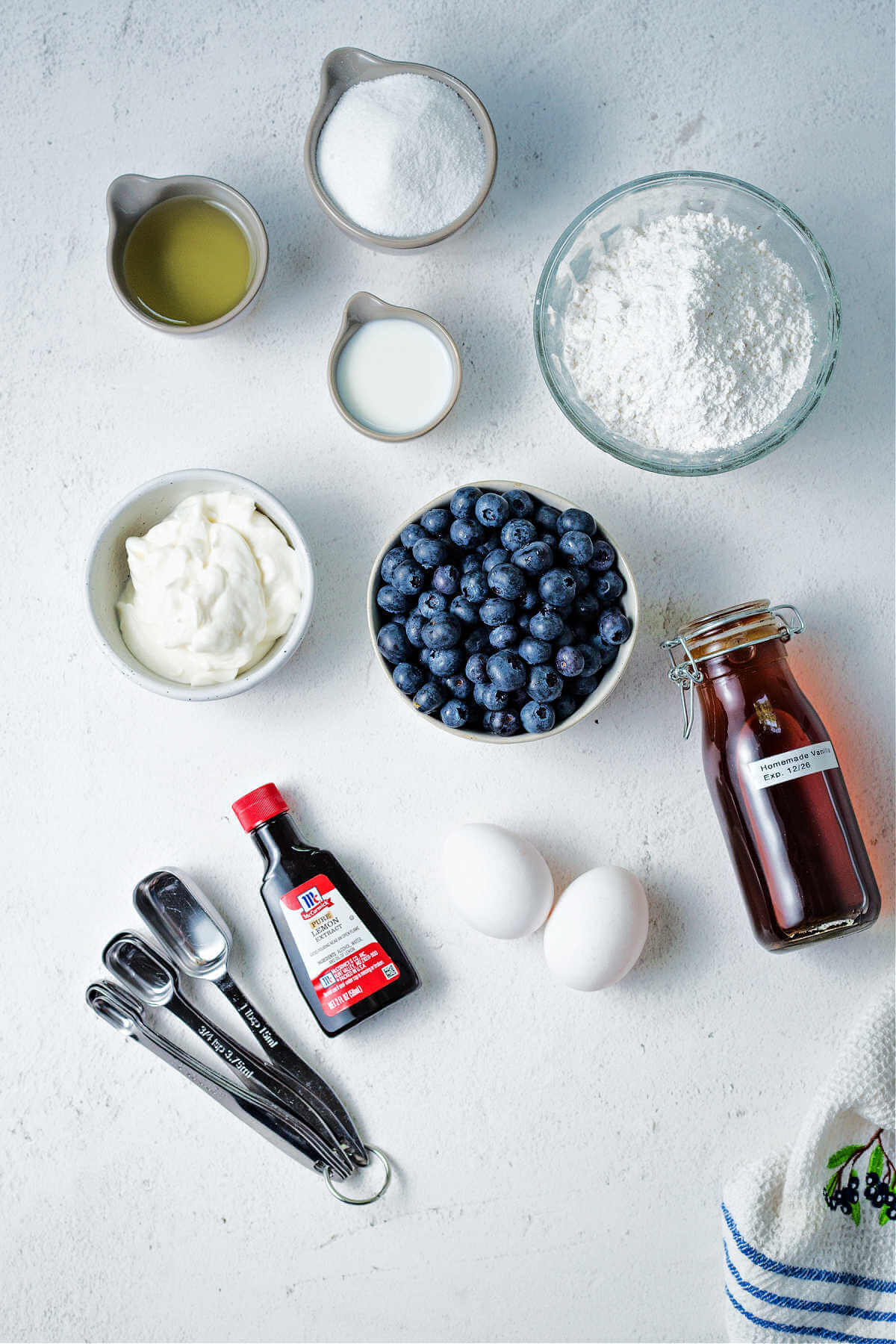 ingredients for sour cream blueberry muffins on a table.