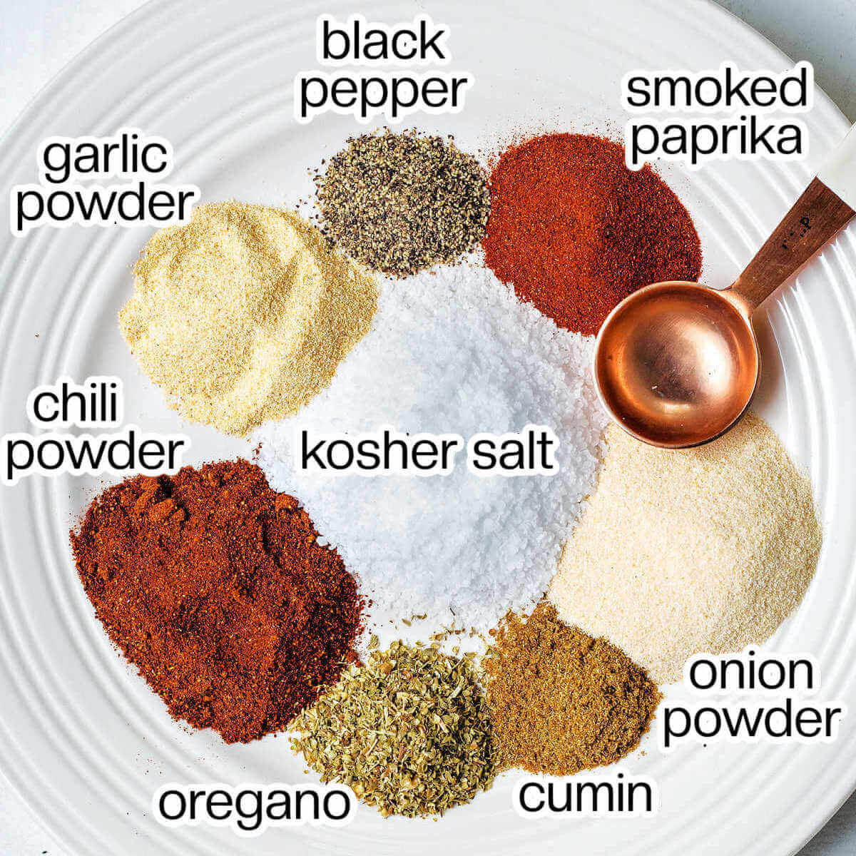 ingredients for homemade steak seasoning on a plate on a table.