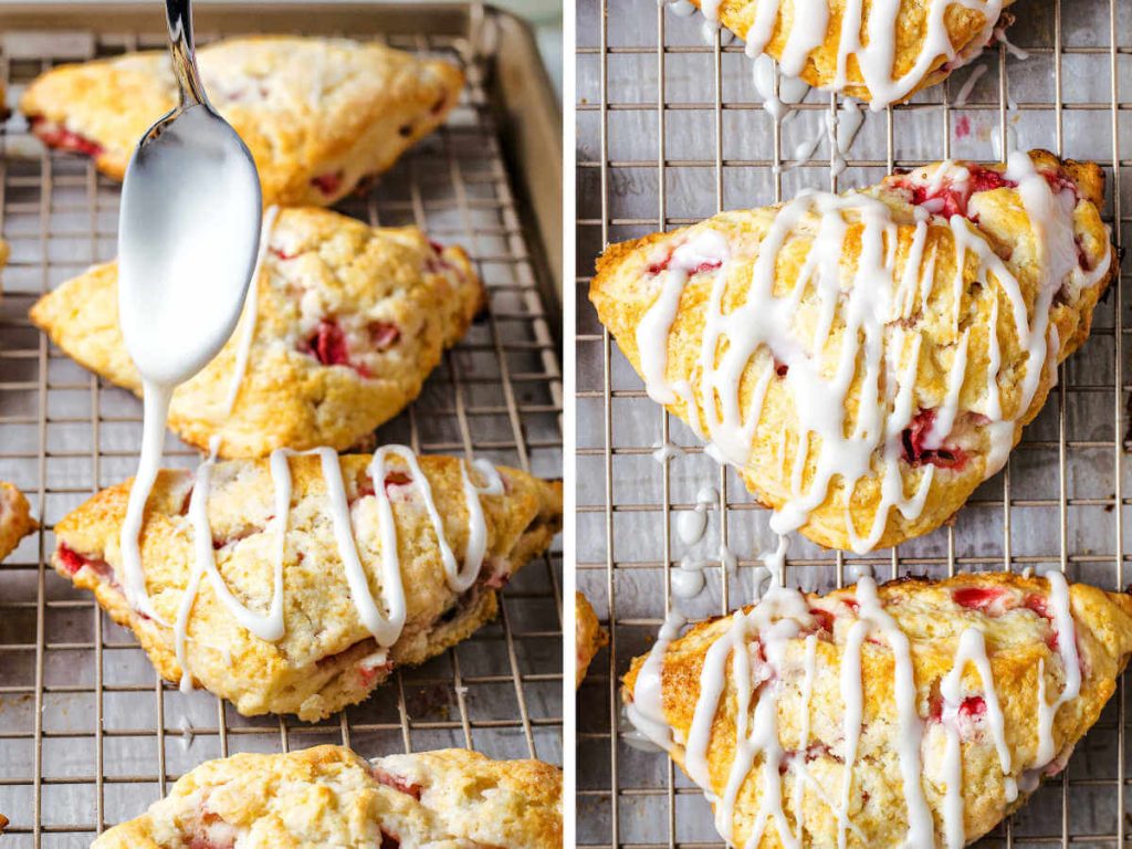 drizzling lemon glaze on top of baked strawberry scones on a wire rack.