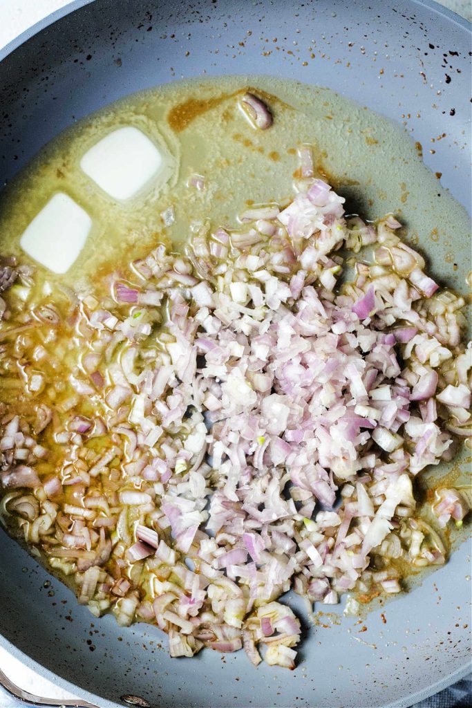 butter in a pan with chopped shallots to make mushroom gravy for pork medallions.