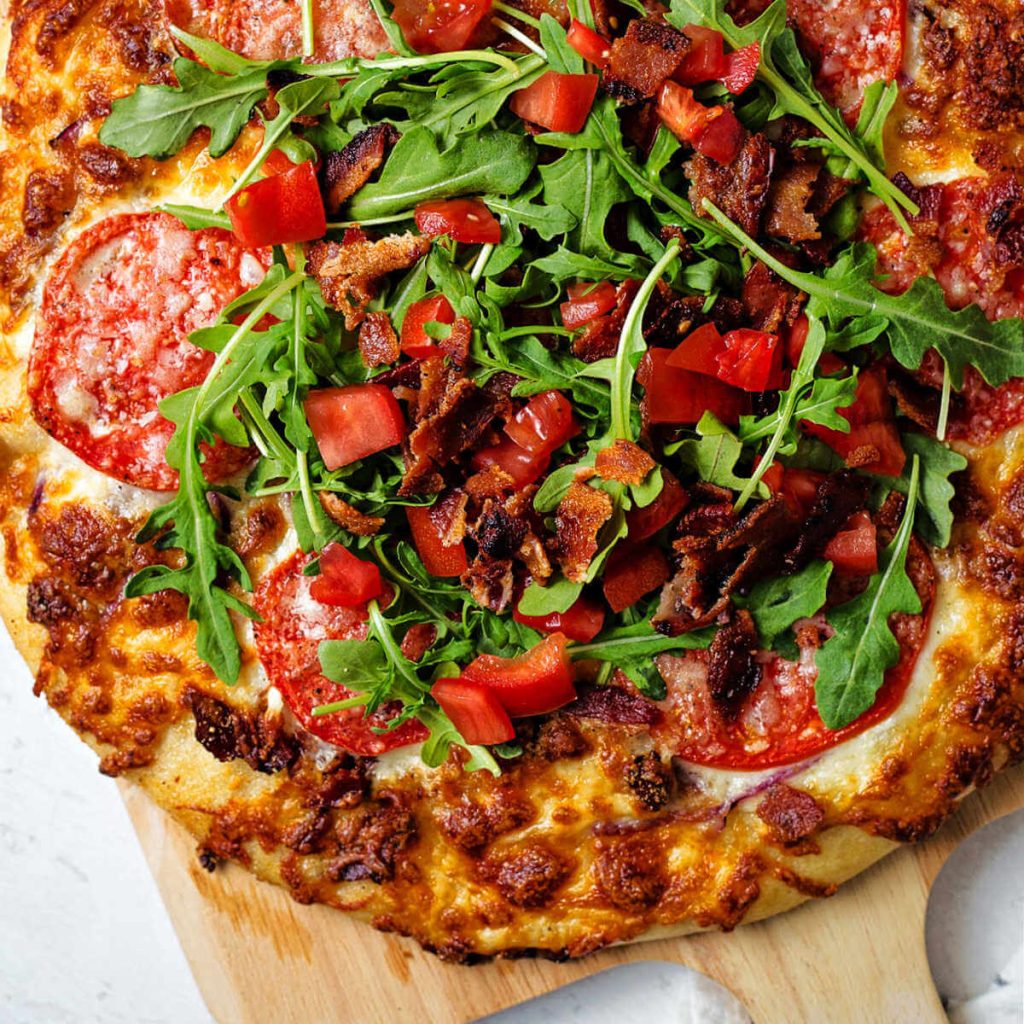 BLT Pizza on a pizza peel.
