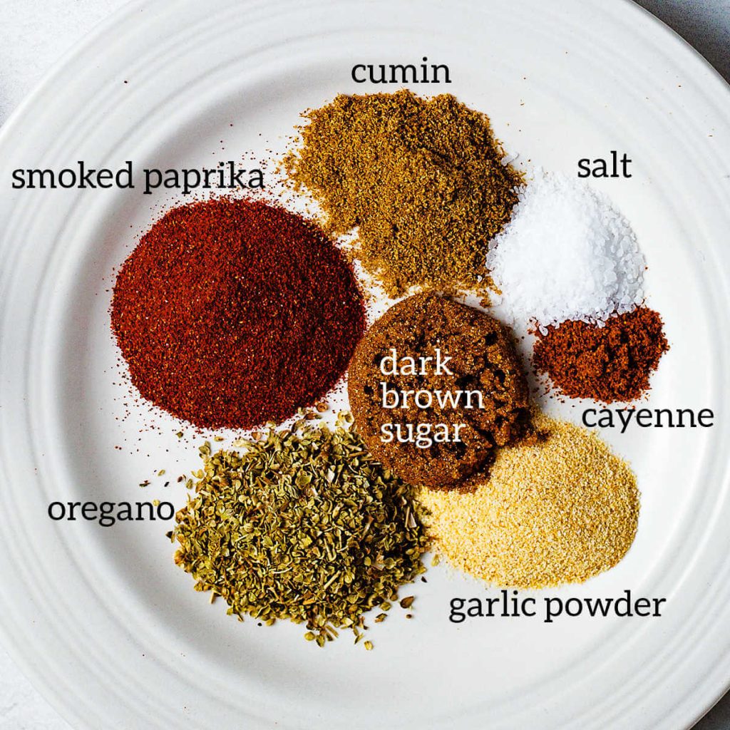 spices for making a cajun rub for fish on a plate on a table.